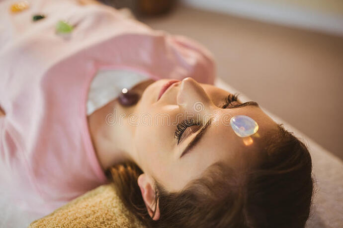 young-woman-crystal-healing-session-therapy-room-56814993