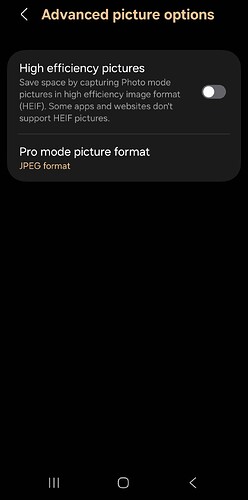 A mobile phone settings screen showing "Advanced picture options" with two settings displayed: "High efficiency pictures" with a toggle switch that's turned off, and "Pro mode picture format" set to "JPEG format". The screen has a dark theme with white and orange text.